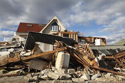 Catastrophic storm damage to residential home with destroyed roof and structural collapse
