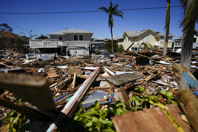 Severe hurricane damage to residential homes with extensive debris and destroyed structures