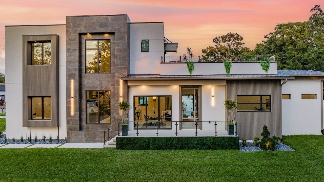 Modern two-story home with contemporary roofing at sunset showcasing professional installation