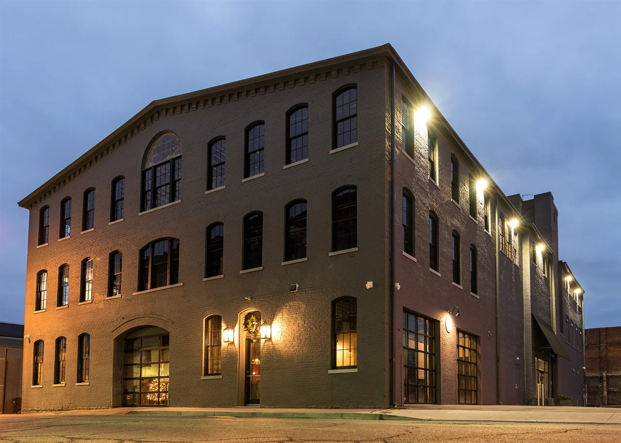 Historic brick commercial building with exterior lighting at twilight after restoration
