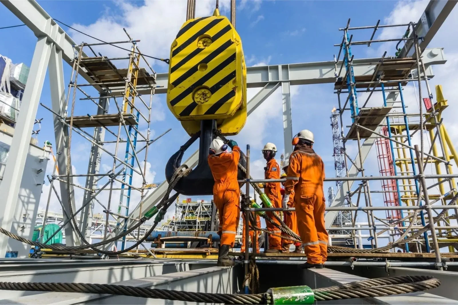 Commercial building construction site with crane and excavator working on concrete structure