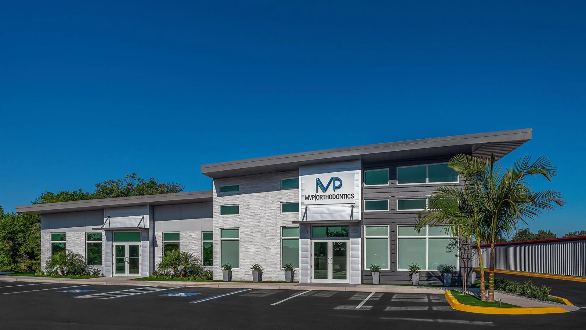 Modern commercial building with professional flat roof installation, MVP Orthodontics office