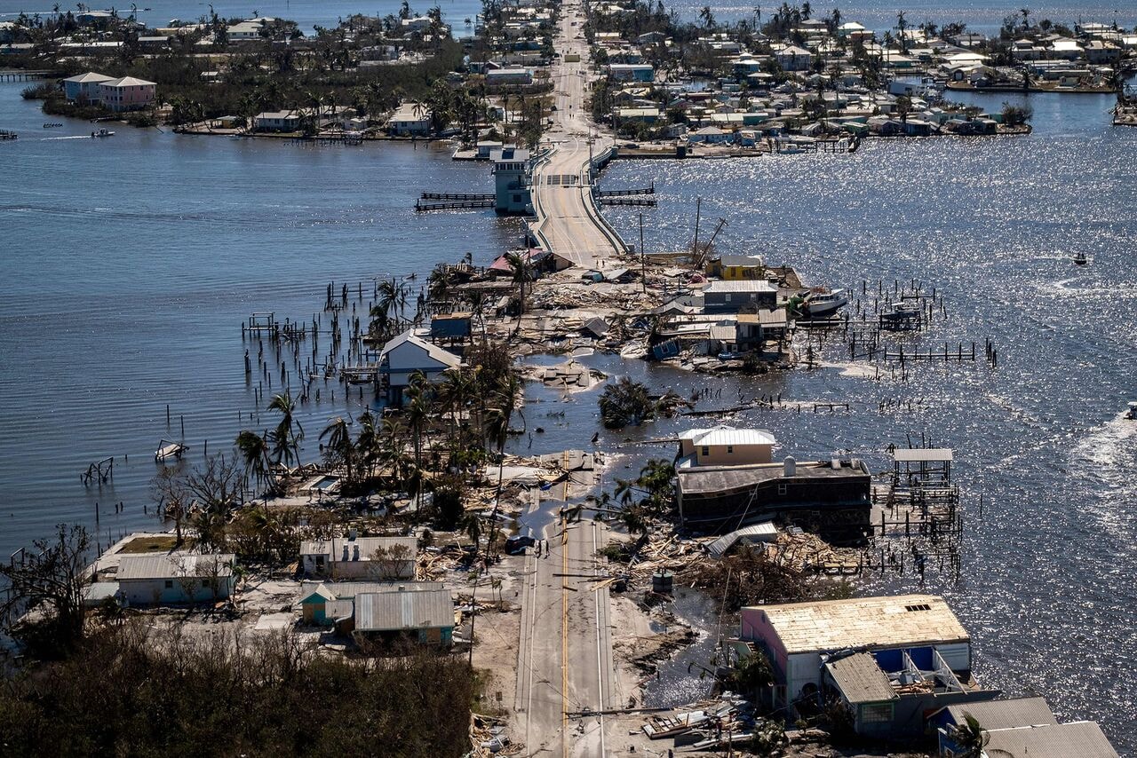 Aerial view of catastrophic hurricane damage to roofs and homes in coastal community