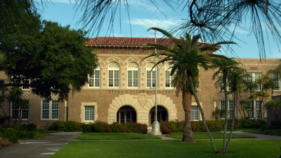 Historic school building featuring clay tile roof and Spanish Mediterranean architecture